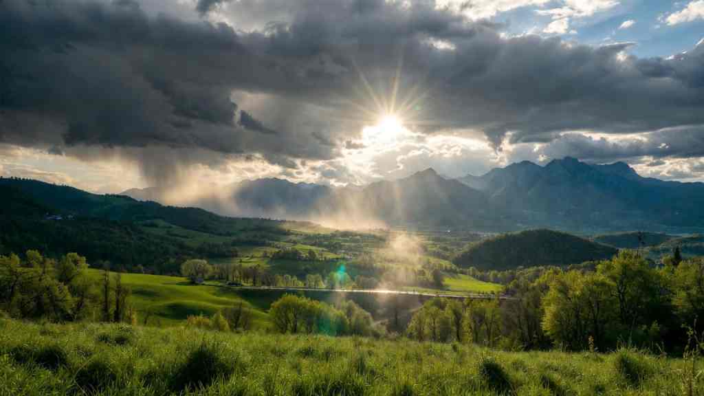 Paesaggio primaverile in Italia con cielo variabile tra sole e nuvole temporalesche dopo un rovescio di pioggia